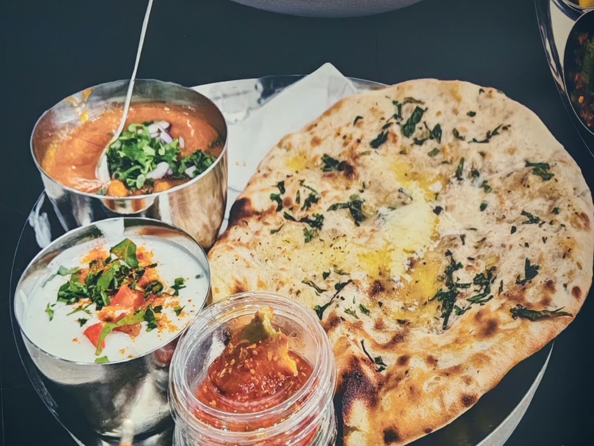 Kulchas served with bowls of sholey